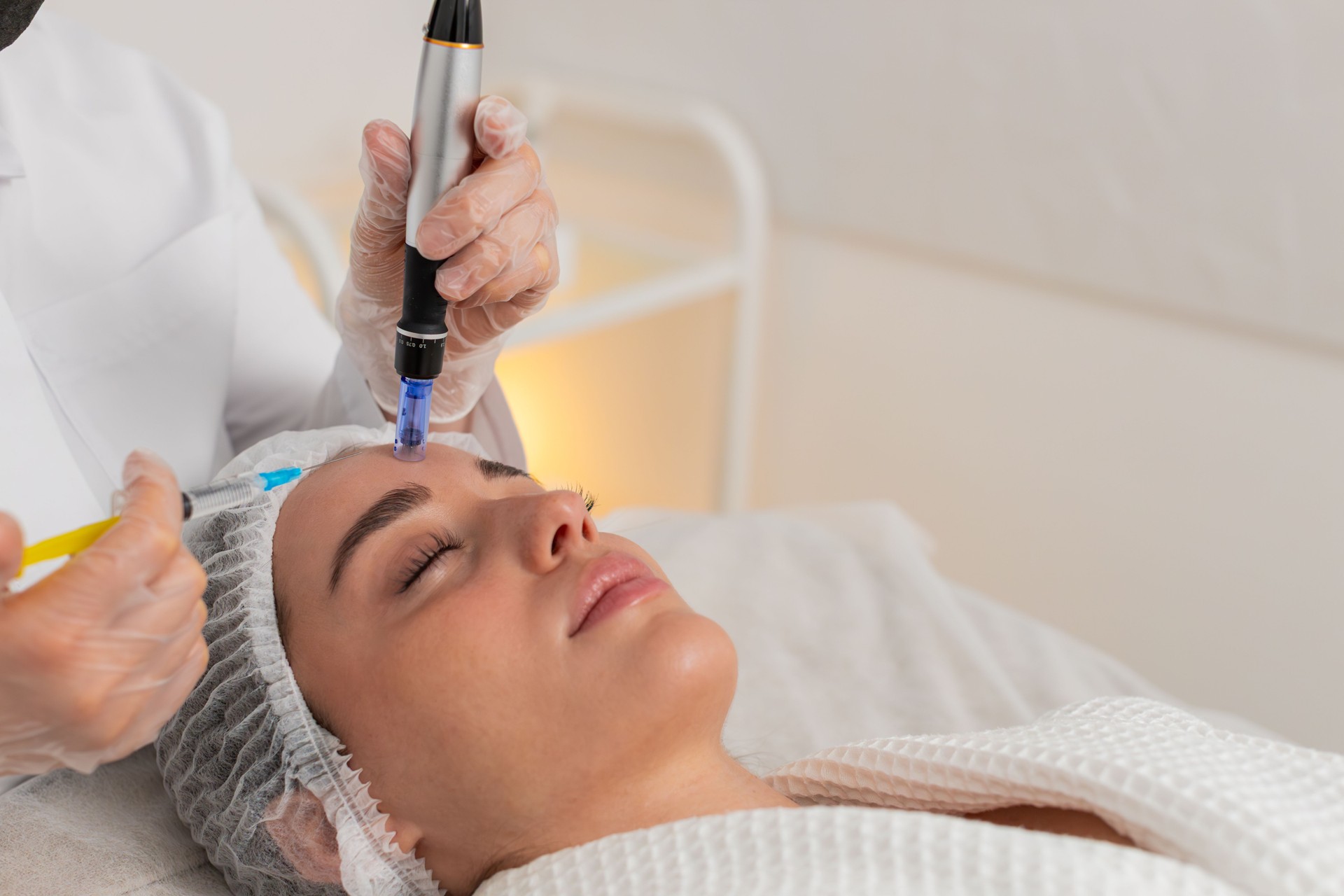Microneedling dermapen mesotherapy for woman face regeneration by cosmetologist in beauty clinic spa
